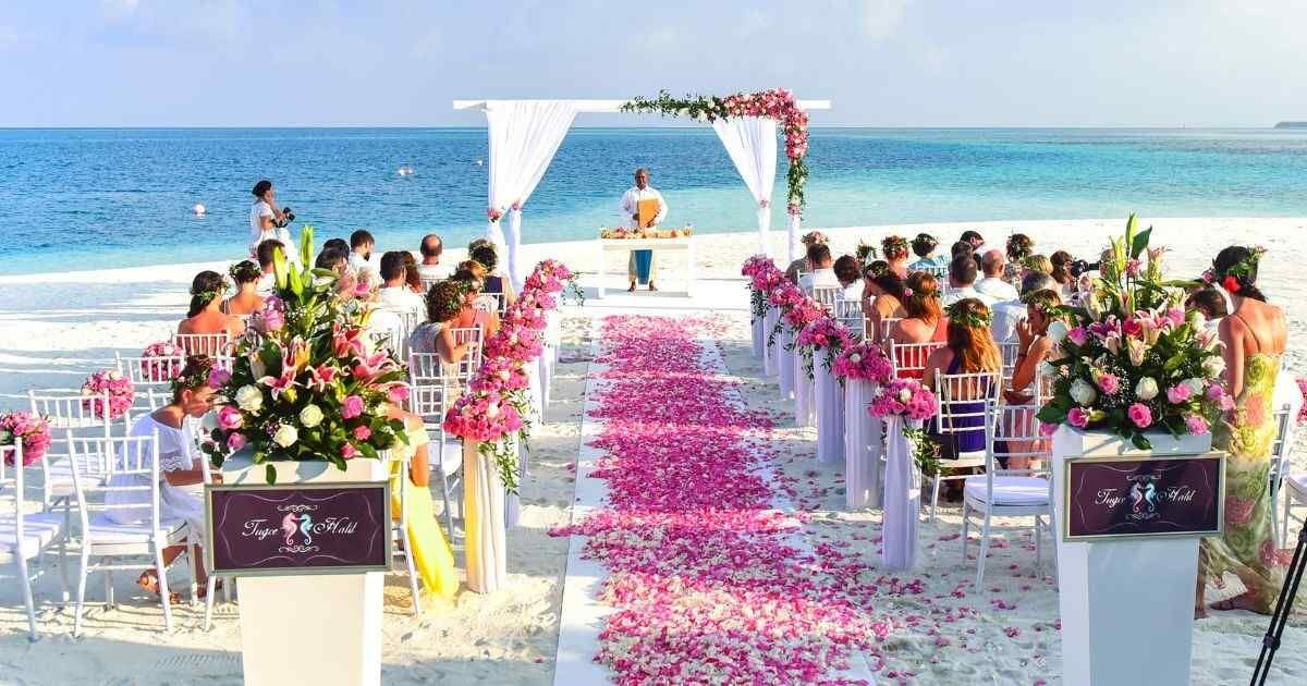 beach wedding with flower pedal runway 