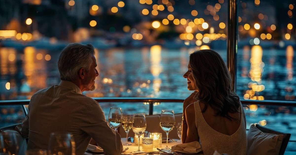 older couple enjoying a romantic evening dinner on a boat 